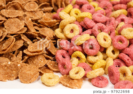 Close-up of wheat flakes and corn rings, top view. 97922698