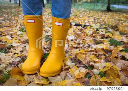 bright autumn. girl in yellow rubber boots walking bright autumn. girl in yellow rubber boots walking 97923004