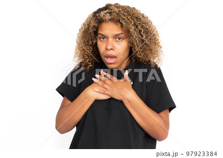 Scared African American woman pressing hands to chest 97923384