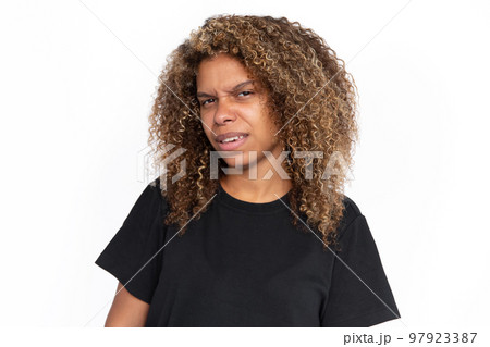 Confused African American woman frowning Confused African American woman frowning 97923387