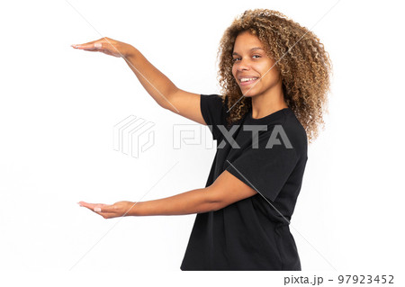 Happy African American woman holding invisible object Happy African American woman holding invisible object 97923452