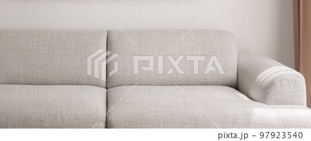 Warm grey sofa close up. Minimalistic furniture concept 97923540