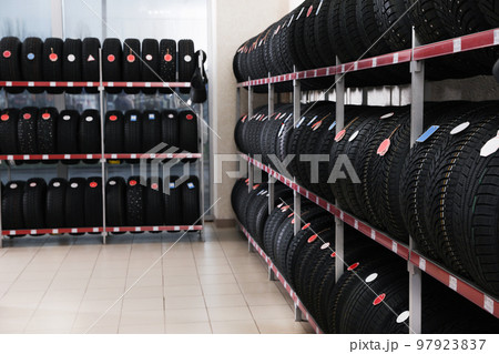 Car tires on rack in auto store 97923837