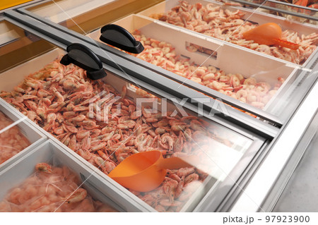 Different fresh raw shrimps on display. Wholesale market 97923900