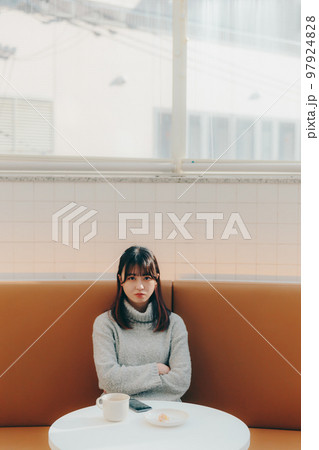 カフェで待ち合わせしている若い女子大生 カフェで待ち合わせしている若い女子大生 97924828