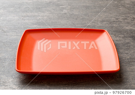 Perspective view of empty square plate on cement background. Empty space for your design Perspective view of empty square plate on cement background. Empty space for your design 97926700