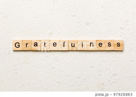 gratefulness word written on wood block. gratefulness text on cement table for your desing, concept 97926863