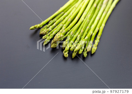 Fresh asparagus on dark background. Fresh asparagus on dark background. 97927179