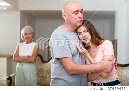 Senior man consoling his daughter 97929475