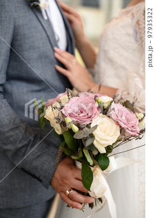 Bride and groom are holding each other's hands during church wedding ceremony 97935322