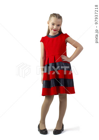 Funny teen girl in a red dress on a white background. Little fashionista with red lipstick. 97937218