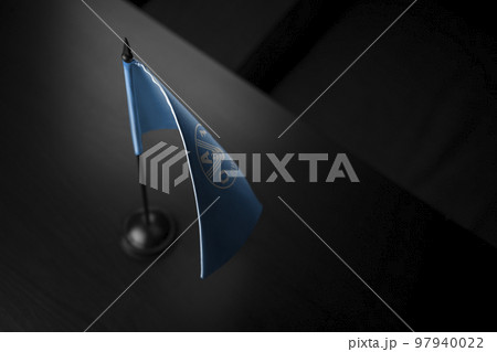 Small national flag of the Food and agriculture organization on a black background 97940022