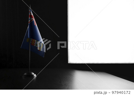 Small national flag of the Cayman Islands on a black background 97940172
