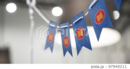 A garland of ASEAN national flags on an abstract blurred background 97940211