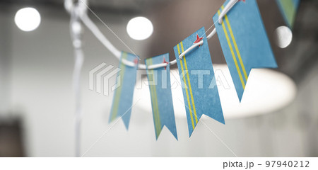 A garland of Aruba national flags on an abstract blurred background 97940212