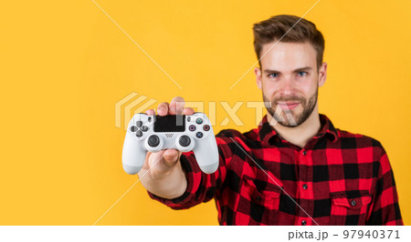Modern technologies. bearded man using virtual reality gamepad. new videogame online. adult entertainment. video games addicted young guy play with console. man playing video game with controller Modern technologies. bearded man using virtual reality gamepad. new videogame online. adult entertainment. video games addicted young guy play with console. man playing video game with controller 97940371