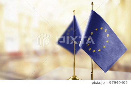 Small national flag of the European Union on a black background 97940402