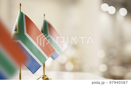Small flags of the South Africa on an abstract blurry background 97940567