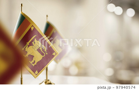 Small flags of the Sri Lanka on an abstract blurry background 97940574
