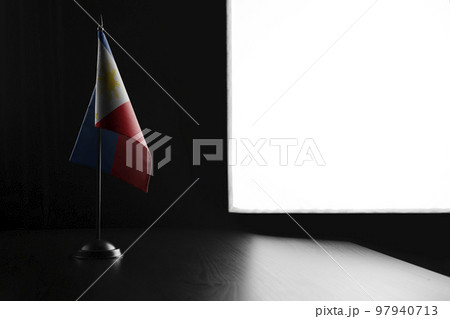 Small national flag of the Philippines on a black background 97940713