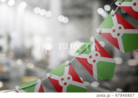 A garland of Burundi national flags on an abstract blurred background 97940807