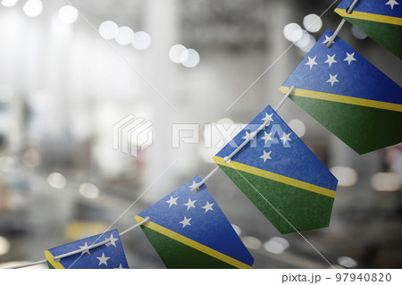 A garland of Solomon national flags on an abstract blurred background 97940820