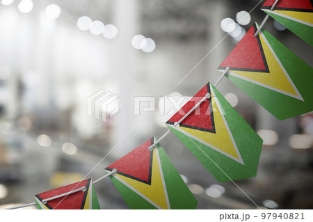 A garland of Guyana national flags on an abstract blurred background 97940821