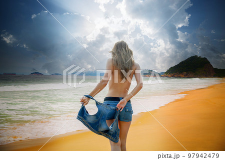 woman taking off clothes on beach, Stock Photo, Picture And Rights Managed  Image. Pic. XXA-12108RS112