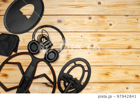 Accessories for metal detector on wooden background Accessories for metal detector on wooden background 97942841