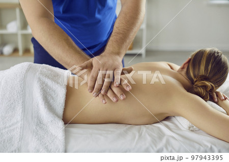 Young woman enjoying relaxing, therapeutic back massage at spa salon or massage room 97943395