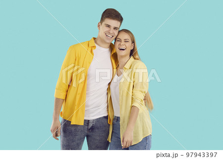 Smiling couple hugging on blue background Smiling couple hugging on blue background 97943397