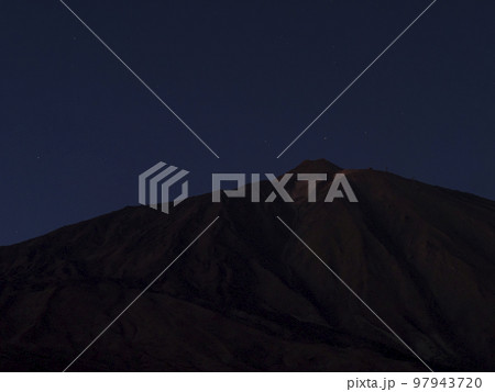 Long exposure night shot of the volcano Pico del Teide at Teide national park with stars on the blue sky. Tenerife Canary islands, Spain 97943720