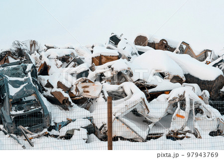 Junkyard with scrap metal and damaged cars during winter season Junkyard with scrap metal and damaged cars during winter season 97943769