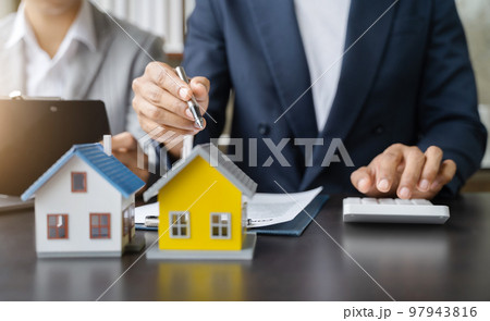 Considering buying a home, investing in real estate. Broker signs a sales agreement. agent, lease agreement, successful deal 97943816