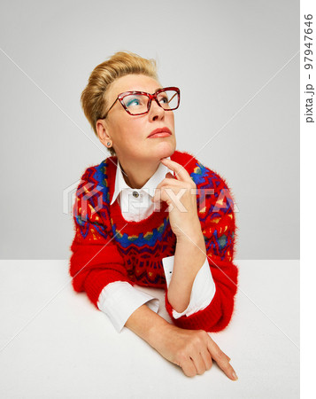 Extravagant, stylish and fashionable mature woman posing isolated over grey studio background. Fashion, style, beauty and emotions concept 97947646