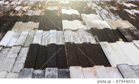 Texture of dark colour traditional double carved roof tiles 97948031