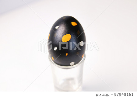 Defocus one black egg with orange and white dots. Close up Easter egg on white background. Minimal Easter celebration concept. Balance harmony concept. Mental health.Out of focus Defocus one black egg with orange and white dots. Close up Easter egg on white background. Minimal Easter celebration concept. Balance harmony concept. Mental health.Out of focus 97948161