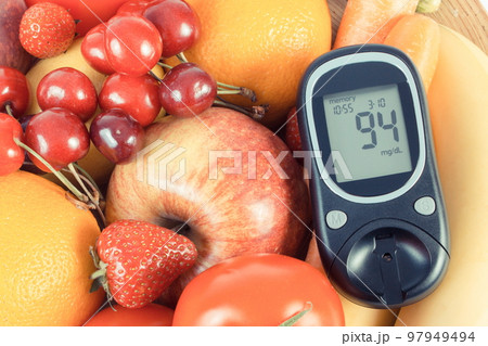 Glucose meter for checking sugar level, blood pressure monitor, fresh  fruits with vegetables and tape measure, slimming, diabetes and prevention  of hy Stock Photo - Alamy