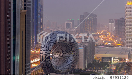 Museum of the Future exhibition space aerial day to night timelapse with iconic torus shape 97951126