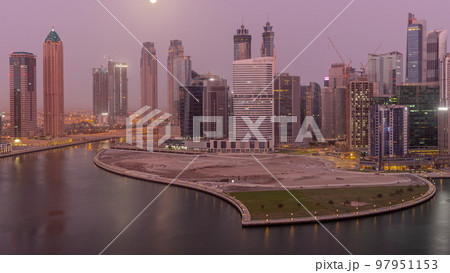 Cityscape of skyscrapers in Dubai Business Bay with water canal aerial night to day timelapse Cityscape of skyscrapers in Dubai Business Bay with water canal aerial night to day timelapse 97951153
