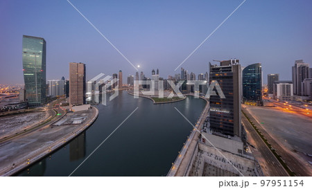 Cityscape of skyscrapers in Dubai Business Bay with water canal aerial night to day timelapse Cityscape of skyscrapers in Dubai Business Bay with water canal aerial night to day timelapse 97951154