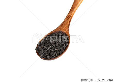 Wooden spoon with black salt isolated on white background. 97951708