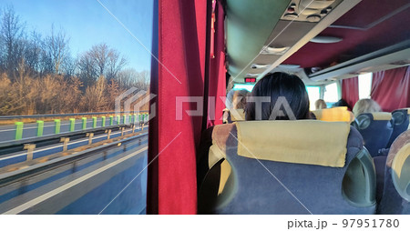 Group of tourist sitting in the bus and looking through the windows at forest Group of tourist sitting in the bus and looking through the windows at forest 97951780