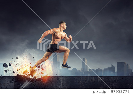Male runner against dark background 97952772