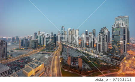 Bay Avenue with modern towers residential development in Business Bay aerial panoramic night to day timelapse, Dubai 97953212