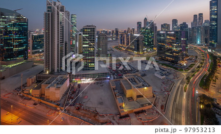 Business Bay Dubai skyscrapers with water canal aerial day to night timelapse. Business Bay Dubai skyscrapers with water canal aerial day to night timelapse. 97953213