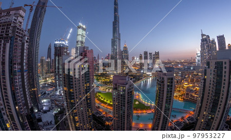 Panorama of Dubai Downtown cityscape with tallest skyscrapers around aerial night to day timelapse. 97953227