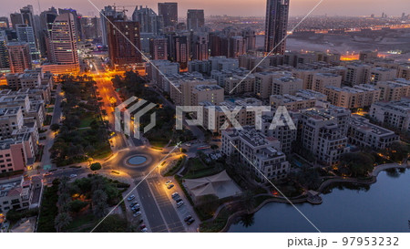 Skyscrapers in Barsha Heights district and low rise buildings in Greens district aerial night to day timelapse. 97953232