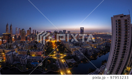 Skyscrapers in Barsha Heights district and low rise buildings in Greens district aerial night to day timelapse. 97953233