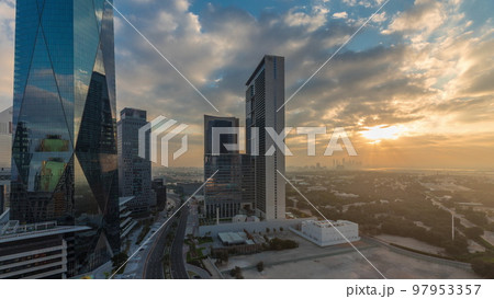 Dubai International Financial district aerial night to day timelapse. Panoramic view of business office towers. Dubai International Financial district aerial night to day timelapse. Panoramic view of business office towers. 97953357